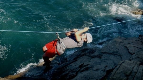 Rope climbing over rapids