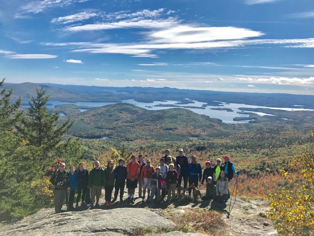 Group photo with Maine landscape in background