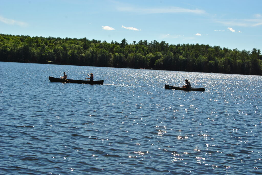two canoes on the lake on a beautiful sunny day