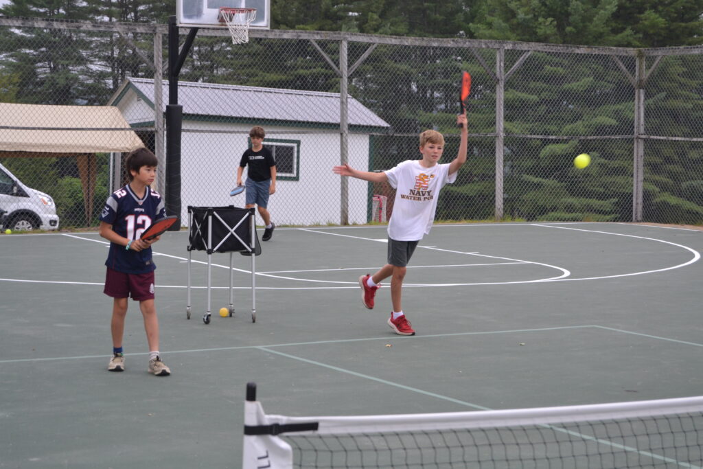 Campers playing pickleball.