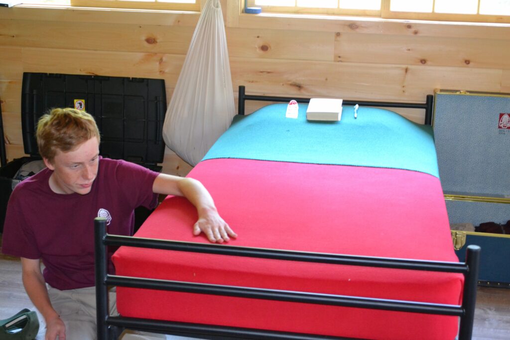 Camper making bed.